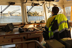 Port Authority employee piloting a vessel in Sydney Harbour