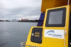Back of a Port Authority vessel with Port Kembla visible in the background