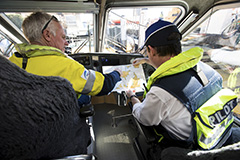 Two Port Authority employees at the helm looking at a map of Sydney Harbour