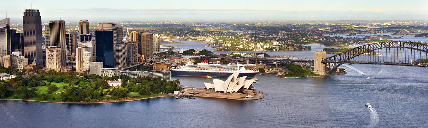 Aerial shot of Sydney Harbour with skyline, opera house and part of the bridge in view