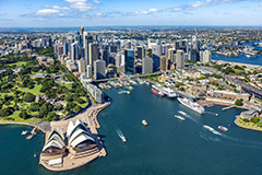 Aerial shot of Sydney Harbour with the Opera house in view, ships entering and exiting the Harbour and two cruise ships double docked at OPT