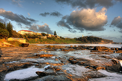 Ocean rock pool at Port of Yamba with town of Yamba in background